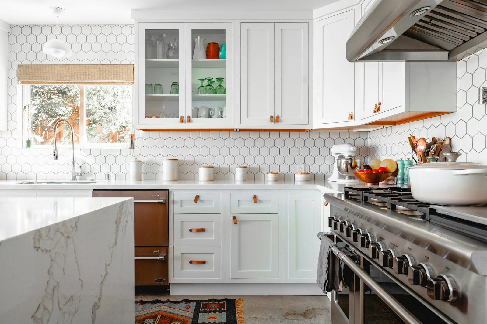 Finished residential kitchen with white cabinets and detailed trim