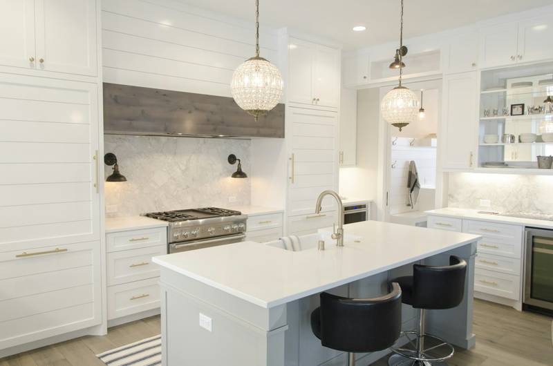 White kitchen cabinets and island installed in a new home