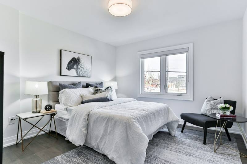 Bedroom with baseboard and window trim